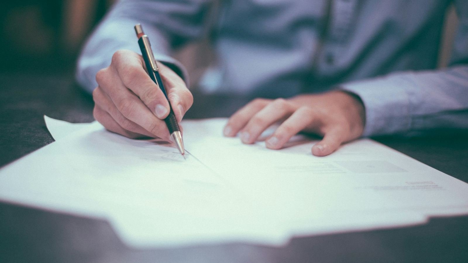 Signing a contract with a fountain pen